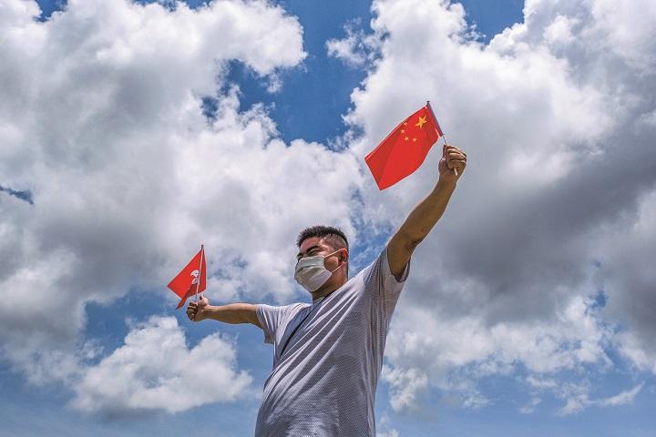 中国旗と香港旗を持つ親中派の香港人 中国旗と香港旗を持つ親中派の香港人